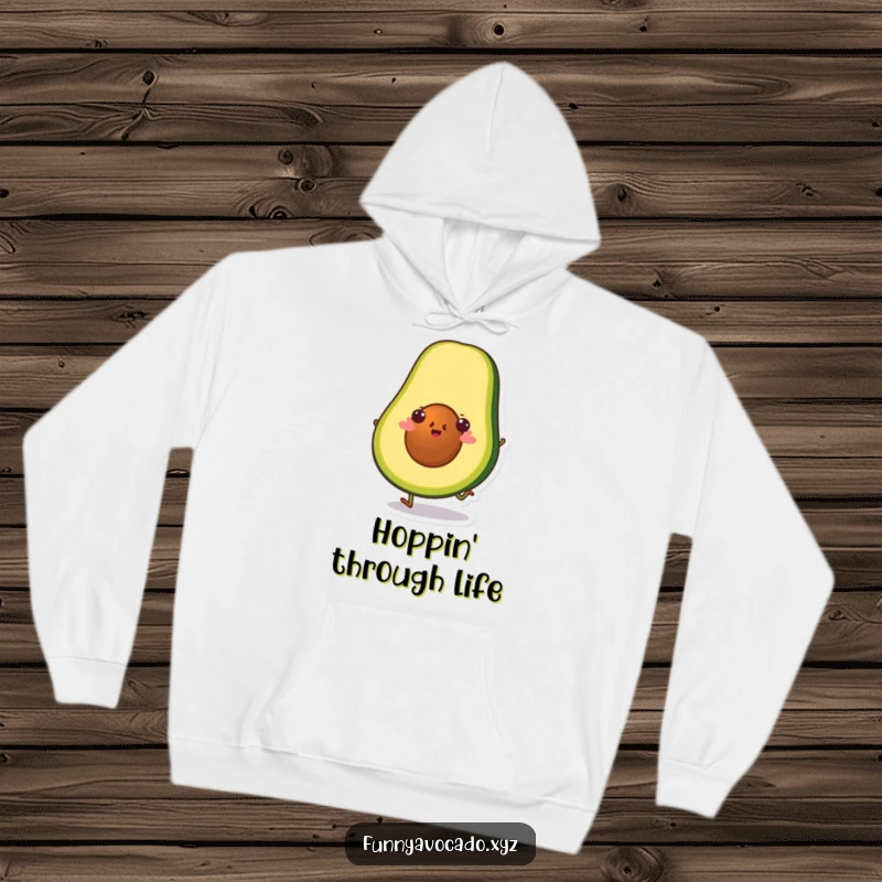 Funny avocado slice character doing a little hop, a soft and humorous hoodie for cozy comfort.