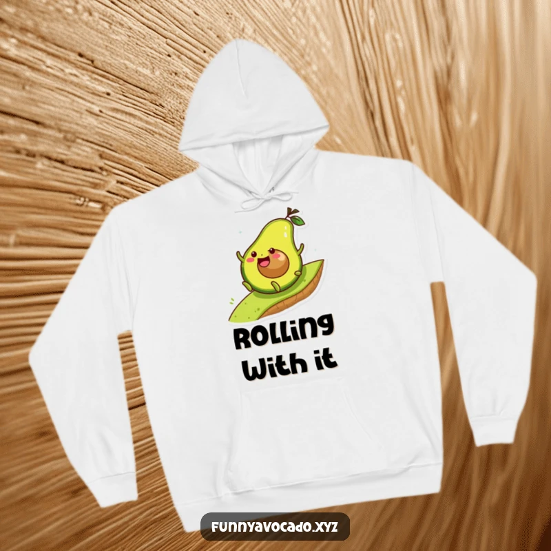 Funny avocado character joyfully rolling down a hill, a soft and humorous hoodie for cozy adventures.